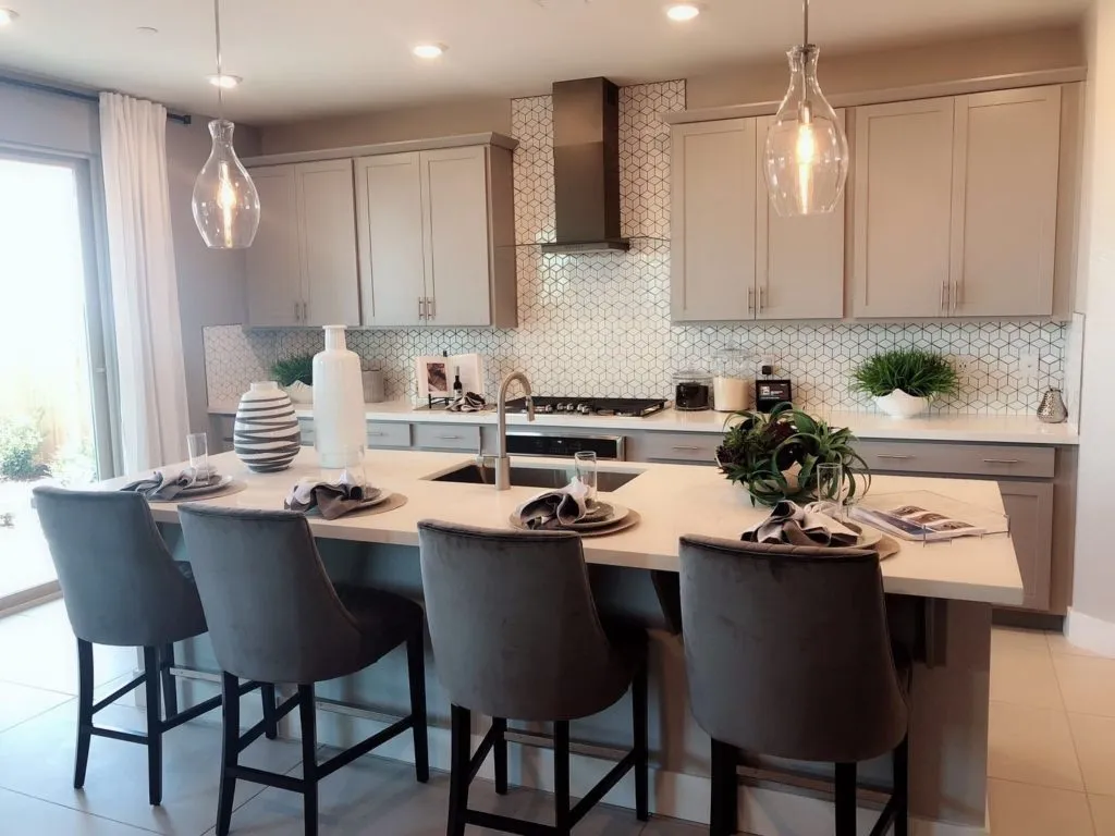 Greige shaker kitchen with patterned backsplash and glass pendants