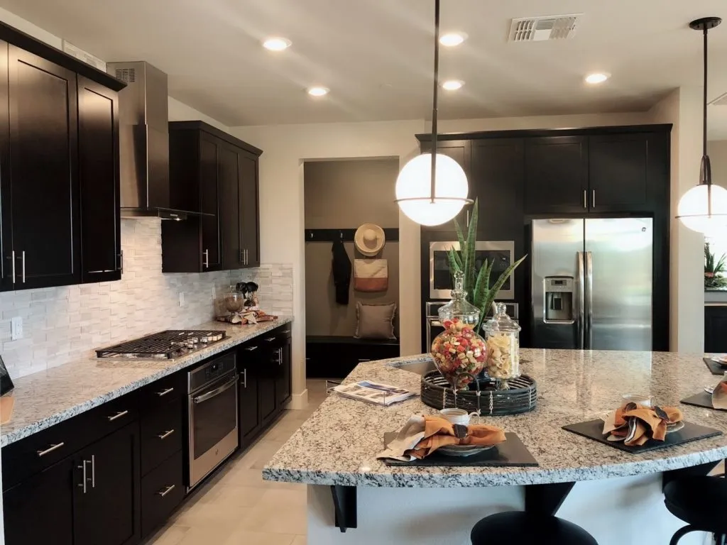 Espresso kitchen with granite island and stainless appliances
